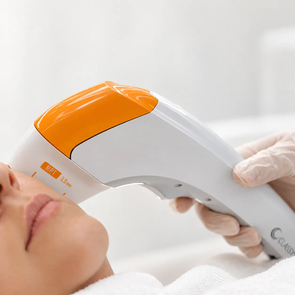 MPT technology applicator during a facial procedure